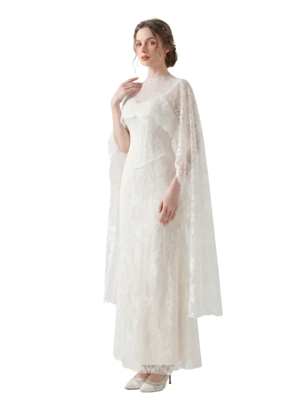 Side view of a model wearing the Laria spaghetti strap lace corset gown in ivory with floral lace, structured corset bodice, sheer lace cape, and romantic trumpet silhouette.