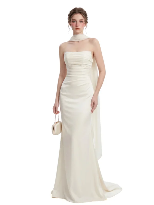 Model wearing an ivory strapless satin mermaid gown with draped cape detail
