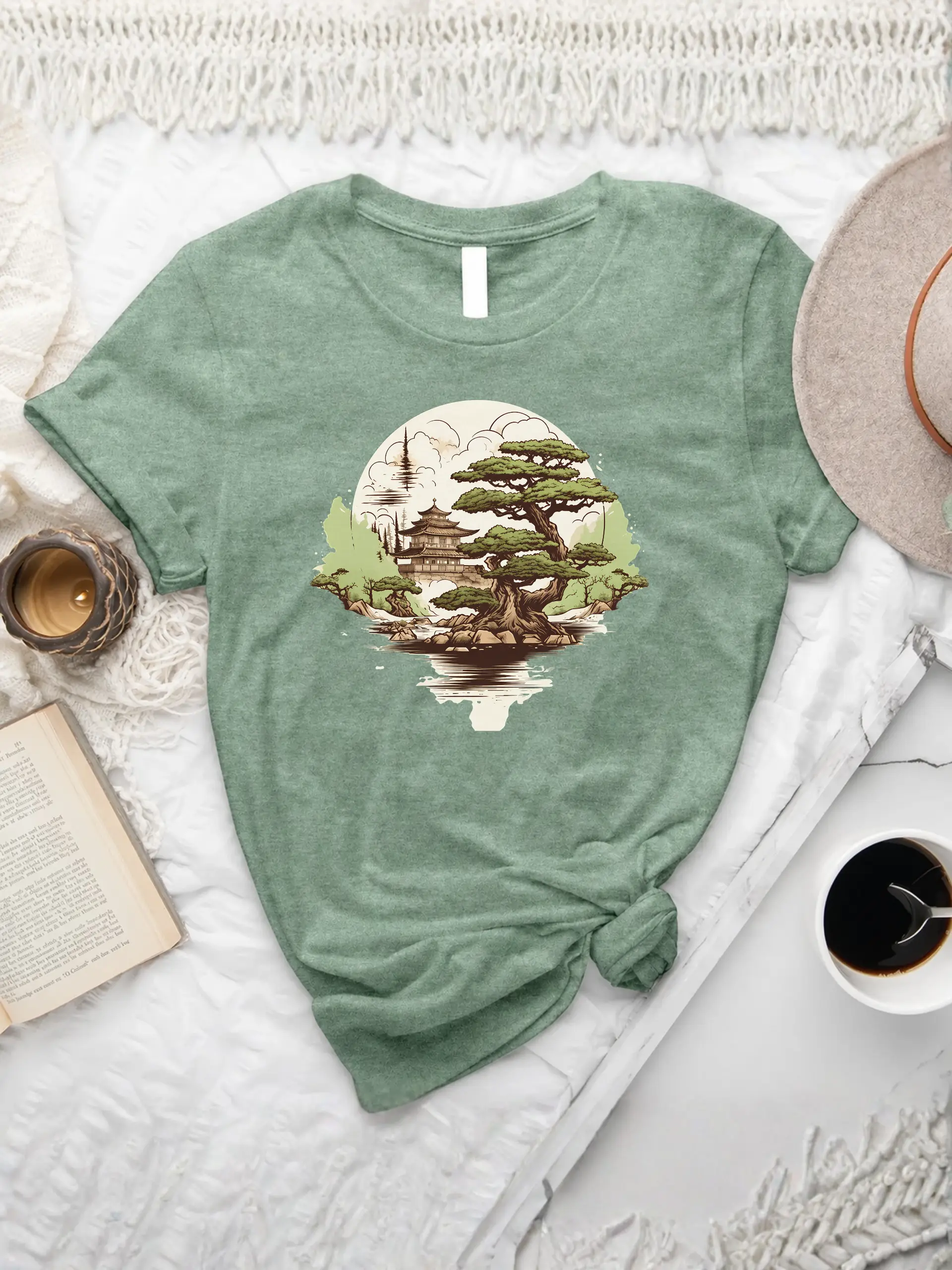 Bonsai Oasis T-shirt in Heather Sage with a Japanese bonsai tree, pagoda, mountain landscape, and water reflection graphic