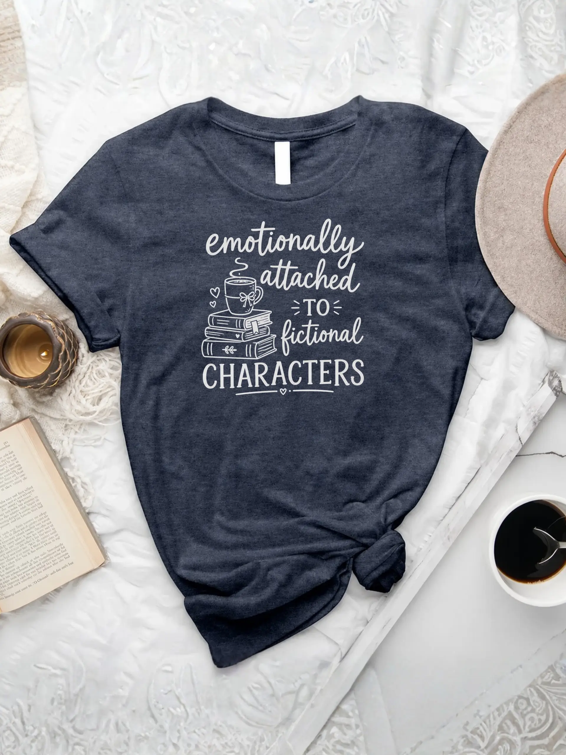 Emotionally Attached T-shirt in Heather Navy with fictional characters quote, stacked books, and coffee mug graphic
